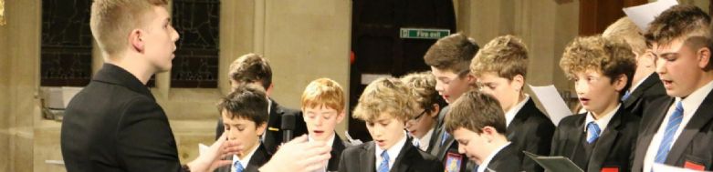 Pupils singing with teacher